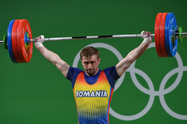 Romania's Gabriel Sincraian competes during the men's weightlifting 85kg event during the Rio 2016 Olympics Games in Rio de Janeiro on August 12, 2016. / AFP PHOTO / GOH Chai Hin