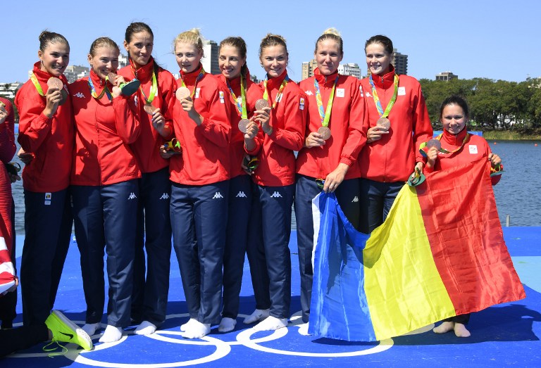 Bronze medallists Romania's Madalina Beres, Romania's Andreea Boghian, Romania's Adelina Bogus, Romania's Roxana Cogianu, Romania's Daniela Druncea, Romania's Laura Oprea, Romania's Mihaela Petrila, Romania's Iuliana Popa and Romania's Ioana Strungaru celebrate on the podium of the Women's Eight final rowing competition at the Lagoa stadium during the Rio 2016 Olympic Games in Rio de Janeiro on August 13, 2016. / AFP PHOTO / Damien MEYER