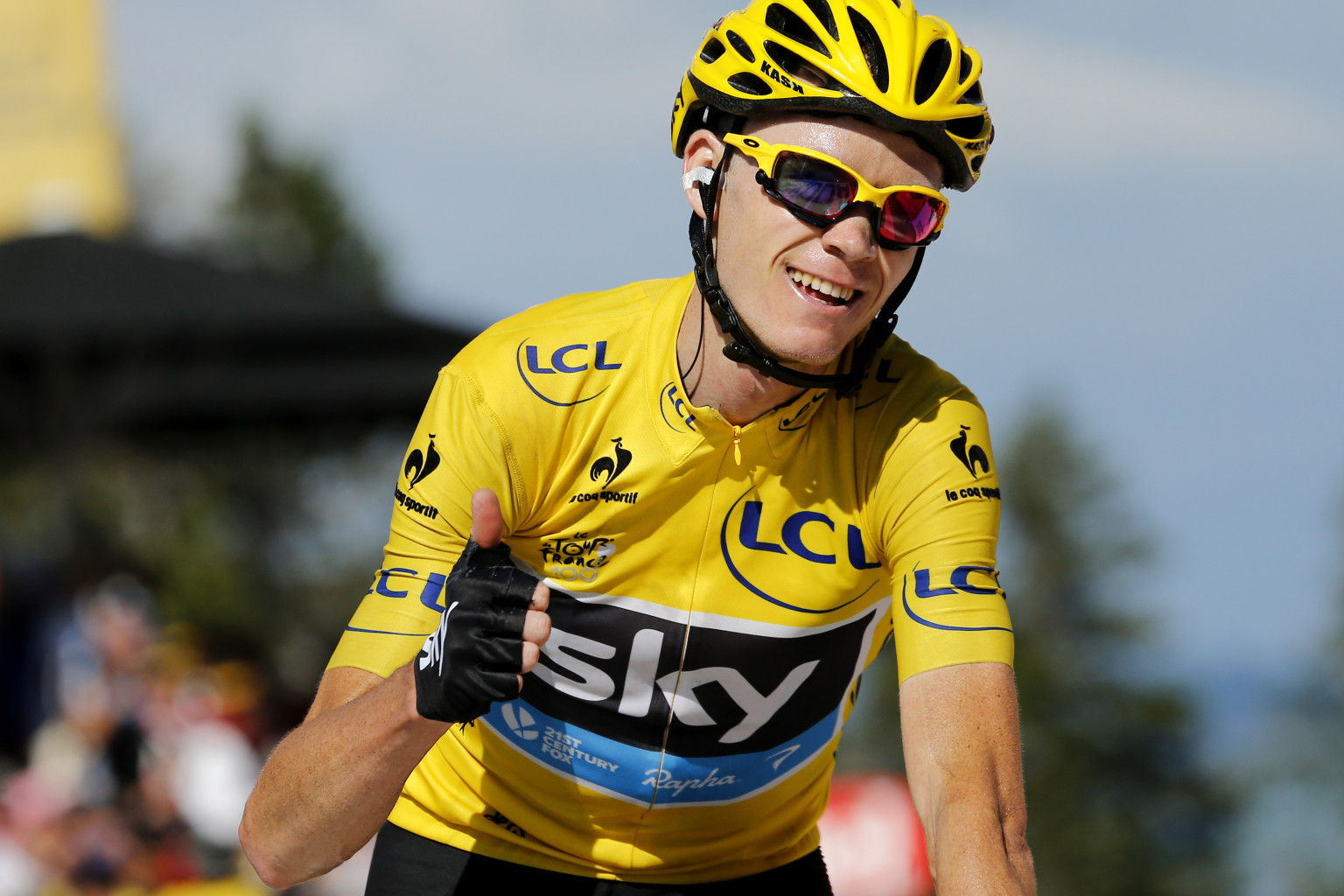 Stage's third placed overall leader's yellow jersey Britain's Christopher Froome thumbs up as he crosses the finish line at the end of the 125 km twentieth stage of the 100th edition of the Tour de France cycling race on July 20, 2013 between Annecy and Annecy-Semnoz, French Alps.  AFP PHOTO / JEFF PACHOUD        (Photo credit should read JEFF PACHOUD/AFP/Getty Images)